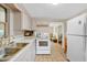 Efficient kitchen with white appliances and ample counter space, perfect for preparing delicious meals at 2409 Garbelia Ave, Orlando, FL 32817