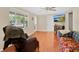 Comfortable living room with hardwood floors and natural light offers a cozy atmosphere for relaxing or entertaining at 2409 Garbelia Ave, Orlando, FL 32817