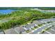 Aerial shot highlighting community, surrounded by lush greenery and a serene lake backdrop at 2449 Southlawn Ln, Clermont, FL 34714
