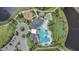 Aerial view showcasing the community pool, clubhouse, playground, and surrounding landscape at 2449 Southlawn Ln, Clermont, FL 34714
