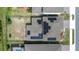 Aerial view showcasing a modern home with solar panels and a well-maintained roof at 2449 Southlawn Ln, Clermont, FL 34714