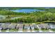 Aerial view displaying a row of houses near a picturesque lake and conservation area at 2449 Southlawn Ln, Clermont, FL 34714