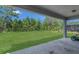 A fenced backyard with healthy, green grass and mature trees at 2449 Southlawn Ln, Clermont, FL 34714