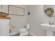 Cozy bathroom featuring a modern toilet and sink, paired with a vanity for storage at 2449 Southlawn Ln, Clermont, FL 34714