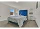 Cozy bedroom with a tufted blue headboard and soft, neutral bedding at 2449 Southlawn Ln, Clermont, FL 34714