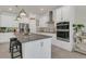 Spacious kitchen with stainless steel appliances, a granite island with seating, and sleek white cabinetry at 2449 Southlawn Ln, Clermont, FL 34714