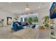 Stylish living area with tile floors and views of a large backyard through sliding glass doors at 2449 Southlawn Ln, Clermont, FL 34714