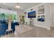 Bright living room with tile floors, a large TV, and sliding glass doors at 2449 Southlawn Ln, Clermont, FL 34714