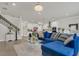 Open-concept living area with modern staircase and open kitchen with stainless appliances at 2449 Southlawn Ln, Clermont, FL 34714