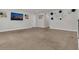 Large carpeted loft area featuring a television and decoratively adorned walls at 2449 Southlawn Ln, Clermont, FL 34714