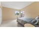 Bright bedroom with a window letting in natural light and a sliding glass door out to the balcony at 2486 Citrus Club Ln # 408, Orlando, FL 32839