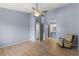 Large bedroom with wood floors, a ceiling fan, and a partial view of an attached bathroom at 2486 Citrus Club Ln # 408, Orlando, FL 32839