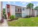 Inviting condo exterior featuring a private balcony, lush landscaping, and vibrant green lawn at 2486 Citrus Club Ln # 408, Orlando, FL 32839