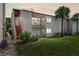 Inviting condo exterior featuring a private balcony, lush landscaping, and vibrant green lawn at 2486 Citrus Club Ln # 408, Orlando, FL 32839