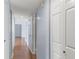 Hallway with wood floors, multiple closets, and neutral wall paint at 2486 Citrus Club Ln # 408, Orlando, FL 32839