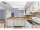 Well-lit kitchen with tile flooring, white appliances, and a breakfast bar at 2486 Citrus Club Ln # 408, Orlando, FL 32839