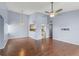 Open-concept living room with hardwood floors, a ceiling fan, and access to the kitchen at 2486 Citrus Club Ln # 408, Orlando, FL 32839