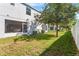 Spacious backyard featuring lush green grass, partial fence and shade trees at 281 Primrose Dr, Davenport, FL 33837