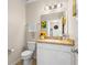Cozy powder room featuring a classic vanity and charming sunflower decor at 281 Primrose Dr, Davenport, FL 33837