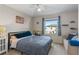 Inviting bedroom with a full-sized bed, a large window, and neutral decor at 281 Primrose Dr, Davenport, FL 33837