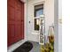 Close-up of a welcoming front door with a decorative sign and neat landscaping at 281 Primrose Dr, Davenport, FL 33837