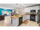 Open kitchen with a large island, modern appliances, and a view of the living area at 281 Primrose Dr, Davenport, FL 33837