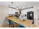 Bright kitchen with white cabinets, a spacious island, and modern appliances at 281 Primrose Dr, Davenport, FL 33837