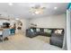 Bright, open living room with tile flooring and a spacious gray sectional sofa at 281 Primrose Dr, Davenport, FL 33837