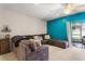 Comfortable living room featuring a gray sectional sofa and access to the screened lanai at 281 Primrose Dr, Davenport, FL 33837