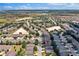 Wide aerial view of a residential community with single-Gathering homes, green spaces, and roadways at 3677 Serena Ln, Clermont, FL 34711