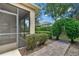 The backyard includes a screened patio with decorative shrubs and brick pavers at 3677 Serena Ln, Clermont, FL 34711