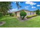 Well manicured backyard featuring green grass, plants, and mulch landscaping at 3677 Serena Ln, Clermont, FL 34711