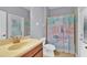 Bathroom featuring a shower with a floral curtain, sink, and tile floor at 3677 Serena Ln, Clermont, FL 34711