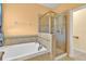 Bright bathroom featuring a large soaking tub with a glass enclosed shower at 3677 Serena Ln, Clermont, FL 34711