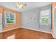 Bedroom with hardwood floors, lots of natural light, and ceiling fan at 3677 Serena Ln, Clermont, FL 34711