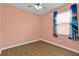 Empty bedroom featuring wood floors and a ceiling fan at 3677 Serena Ln, Clermont, FL 34711