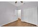 Neutral bedroom featuring wood-look floors, closet, and doors at 3677 Serena Ln, Clermont, FL 34711