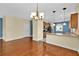 Cozy dining area with pendant lighting showcases beautiful hardwood floors and adjacent kitchen access at 3677 Serena Ln, Clermont, FL 34711