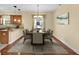 Elegant dining room with a large table, chandelier, and natural light perfect for Gathering gatherings at 3677 Serena Ln, Clermont, FL 34711