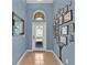 Charming foyer boasts decorative details and ample natural light, offering a warm welcome to guests at 3677 Serena Ln, Clermont, FL 34711