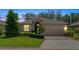 Well-maintained one-story home featuring a manicured lawn, traditional architecture, and a two-car garage at 3677 Serena Ln, Clermont, FL 34711
