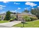Inviting single-story home with a two-car garage, a well-maintained lawn, and mature landscaping at 3677 Serena Ln, Clermont, FL 34711