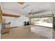 Garage with epoxy flooring, shelving, and an open garage door at 3677 Serena Ln, Clermont, FL 34711