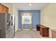 Bright kitchen nook with stainless refrigerator and built in desk at 3677 Serena Ln, Clermont, FL 34711