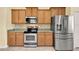 Updated kitchen showcasing stainless steel appliances and granite countertops at 3677 Serena Ln, Clermont, FL 34711