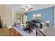 Bright living room features stylish furniture, ceiling fan, and sliding door access to outdoor space at 3677 Serena Ln, Clermont, FL 34711