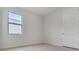 Bright bedroom with tile floor, modern window, and white painted door and trim at 3975 Kennebunk Loop, Mount Dora, FL 32757
