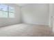 Bedroom showcasing neutral carpet, large modern windows, and white painted trim at 3975 Kennebunk Loop, Mount Dora, FL 32757