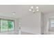 Minimalist living area with tile floors, large sliding glass door, and bright, neutral paint at 3975 Kennebunk Loop, Mount Dora, FL 32757