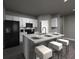 Contemporary kitchen with granite island, barstool seating, stainless steel appliances, and ample cabinet space at 4533 Cross Prairie Pkwy, St Cloud, FL 34772